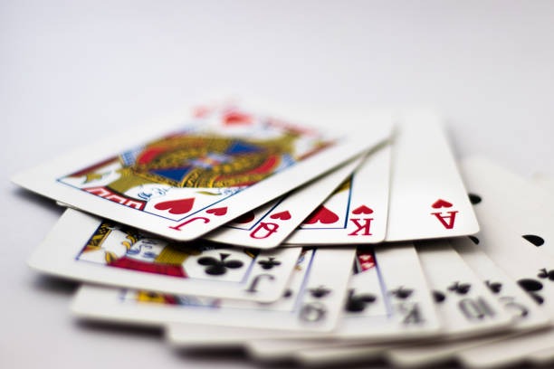 Live Casino Hold'em table with dealer and community cards displayed on screen